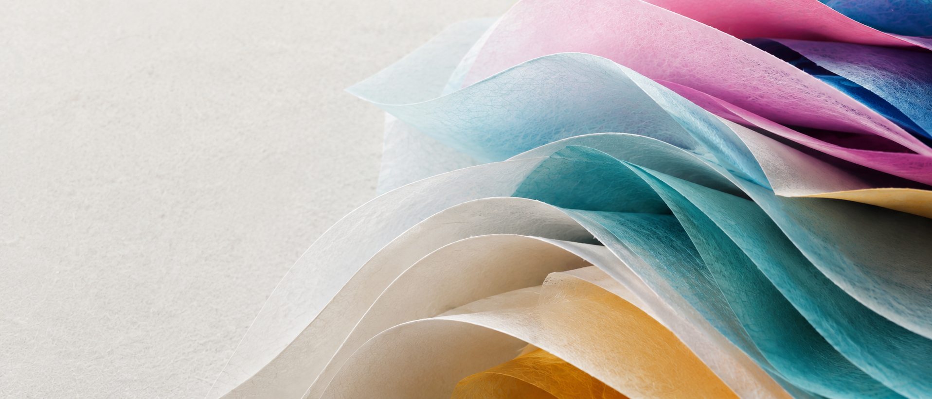 Flowing sheets of richly coloured and textured paper